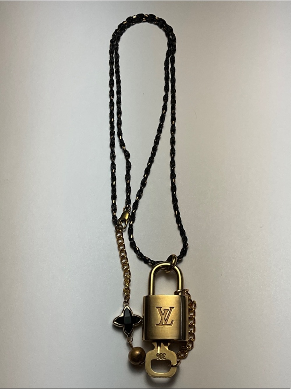Authentic Louis Vuitton Brass Padlock and Key put on a chain